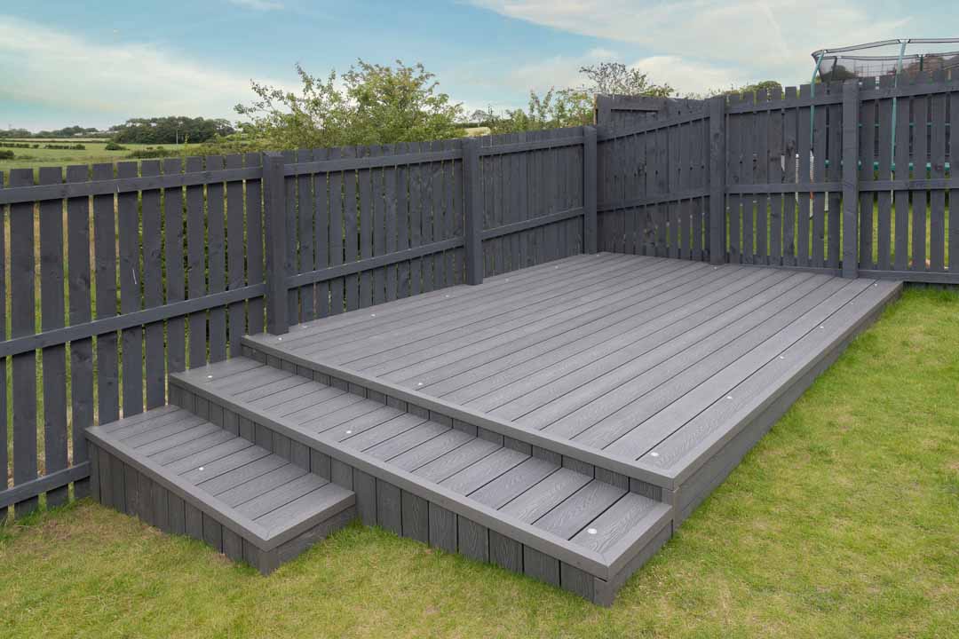 Newlly Constructed Decking Over Two Levels With Deck Lighting Installed And In Ash Grey Colour With Summer House Painted In The Same Matching Colour.good Image For A Landscape Gardiner