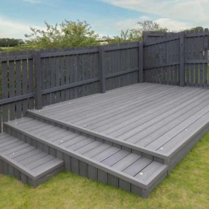 Newlly Constructed Decking Over Two Levels With Deck Lighting Installed And In Ash Grey Colour With Summer House Painted In The Same Matching Colour.good Image For A Landscape Gardiner